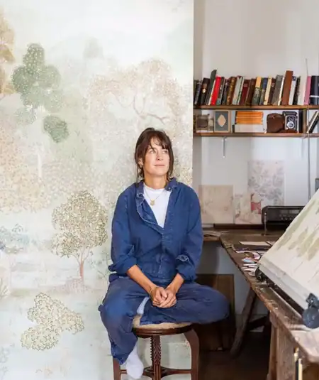 A detailed pattern shot of the Lost Lands Mineral wallpaper mural from Empire Wallpaper, designed by artist Charlie Calder-Potts. The design features a layered landscape of trees and shrubs where subtle animals are hidden, reflecting a sense of childhood magic and imagination. The Mineral palette provides a serene and sophisticated aesthetic, making it a perfect artistic focal point for high-end contemporary and heritage-inspired interior design projects.